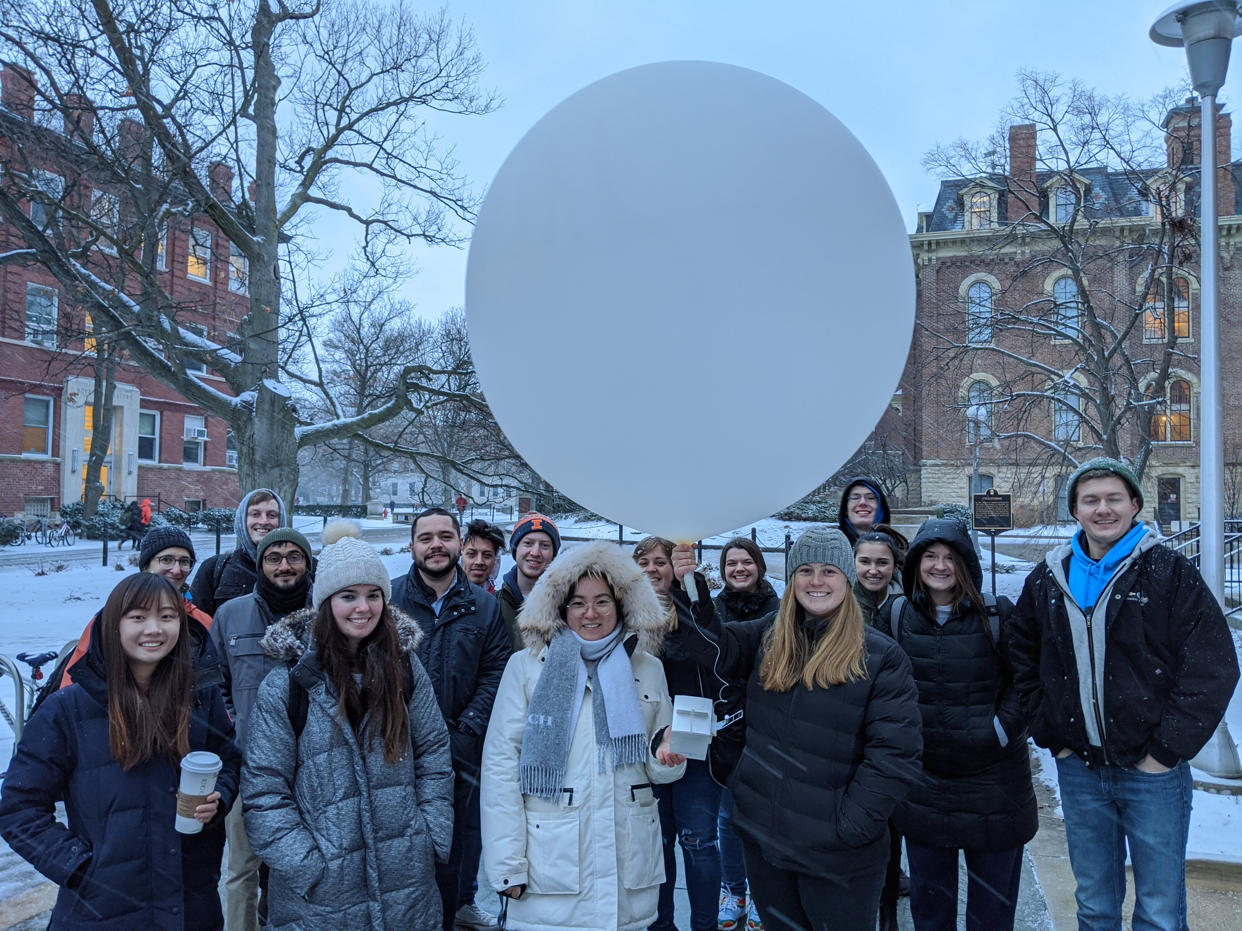 Students launching a weather balloon behind the UIUC Natural History Building