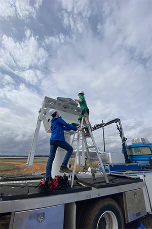 ATMS graduate students Leanne Blind-Doskocil and Eddie Wolff prepare the C-band radar on Wheels